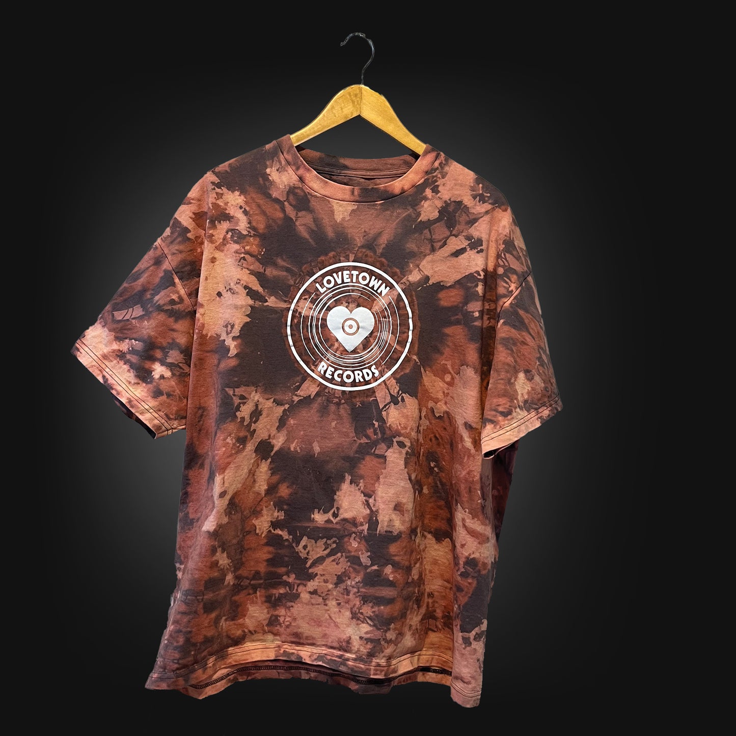 Grey t-shirt with a white logo that says "lovetown records", tied dyed with bleach.