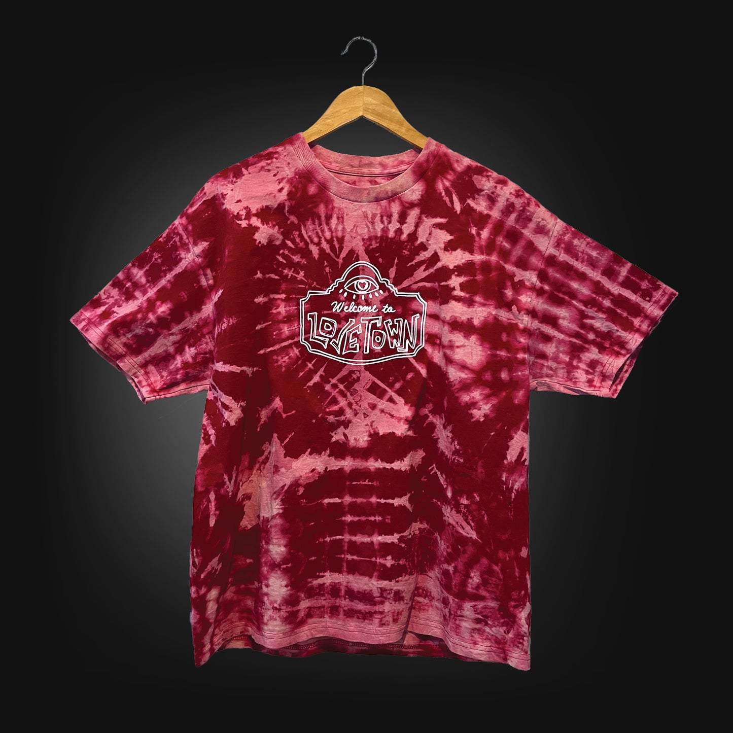 red t-shirt with a white logo that says "welcome to lovetown" tie dyed with bleach